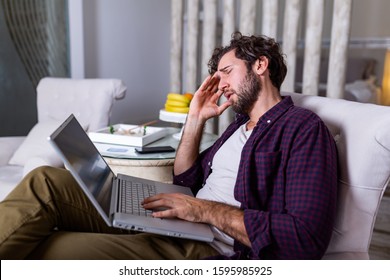 Young tired manager sitting at home surrounded with papers and laptop computer having tired look holding his hand on head having pain closing his eyes being sleepy and exhausted. Tiredness - Powered by Shutterstock