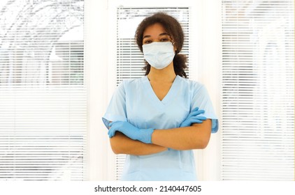 Young Tired Overworked African American Medical Worker Wearing Protective Face Mask Looking To The Camera With Frustrated Expression. Healthcare Workers During COVID-19 Pandemic