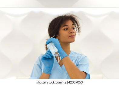 Young Tired Overworked African American Medical Worker Take Out Protective Face Mask Looking To The Camera With Frustrated Expression. Healthcare Workers During COVID-19 Pandemic