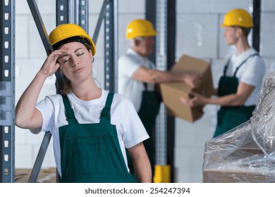 Young Tired Woman Working In Warehouse