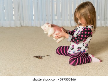 Young Toddler Getting Money From Pottery Piggy Bank