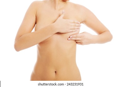 Young topless woman is doing breast self examination. Over white background.