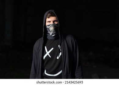 A Young Tough Guy In A Buff Mask And Hood . Hooligan, Robber, Aggressive Anarchist, Bully Or Resistance Fighter, System Protester