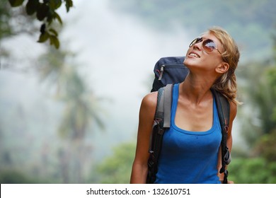 Young Tourist With Backpack Walking In Tropical Forest