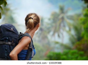 Young Tourist With Backpack Walking In Tropical Forest