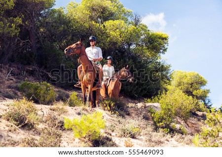 Young Tourist Couple Horseback Riding