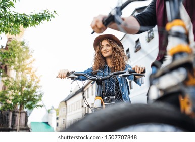 Young Tourist Couple Travellers With Electric Scooters In Small Town, Talking.