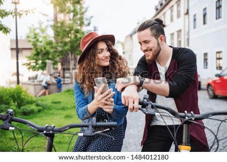 Similar – Image, Stock Photo Girl using electric scooter in the street in downtown rented by using service on smartphone. Candid people, real moments, authentic situations