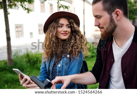 Similar – Image, Stock Photo Girl using electric scooter in the street in downtown rented by using service on smartphone. Candid people, real moments, authentic situations