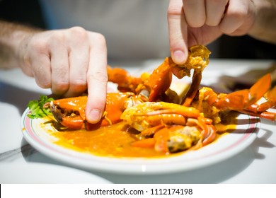 Young Tourist Eating Singapore Style Hot Chilli Crab Served On China Town. South East Asia Seafood Dish.