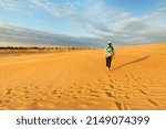 A young tourist hiking on sand dune at Jockey
