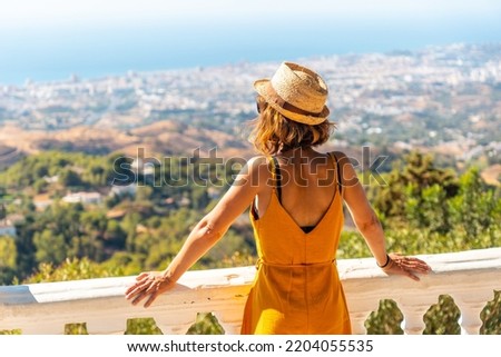 A young tourist looking from the viewpoint in the municipality of Mijas in Malaga. Andalusia