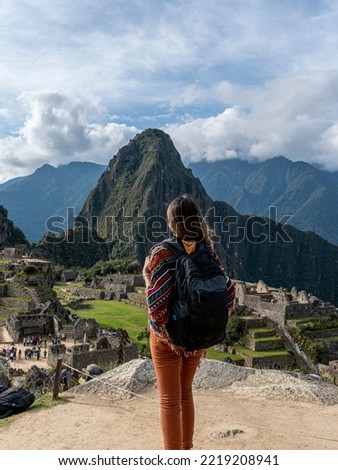 young tourist observes Machu Picchu, Cusco, Peru