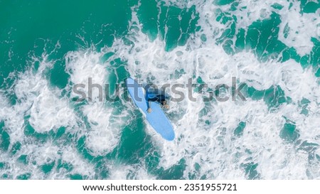 young tourist surfing at Arugam bay sea , Sri Lanka 