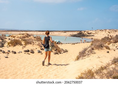 A young tourist visiting La Concha beach on Isla de Lobos, next to the north coast of the island of Fuerteventura, Canary Islands. Spain