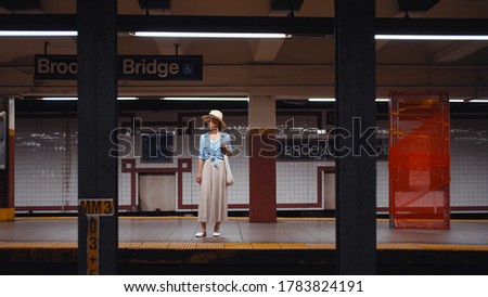 Young tourist waiting for a train at the station in the subway, New York City