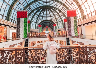 A young tourist walks through one of the largest shopping centers in Dubai - Emirates Mall. Travel in UAE concept