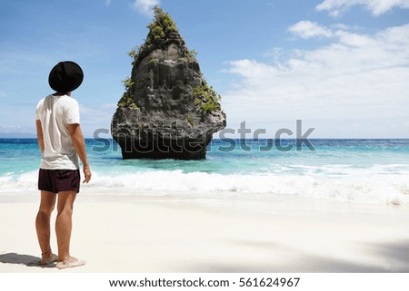 Similar – Man standing barefoot on a wooden walkway