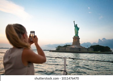 Young Tourist Woman Is Taking Picture About The Statue Of Liberty