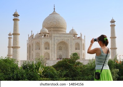 Young Tourist Woman Taking Picture Of Taj Mahal