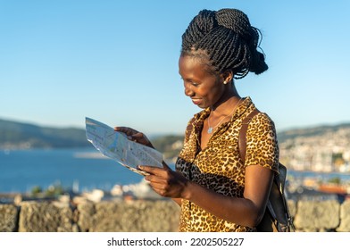 Young tourist woman viewing a map in an coastal city in Spain visiting a European city	 - Shutterstock ID 2202505227