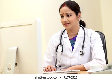 Young Tradtional Female Doctor Working On Computer