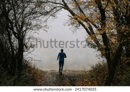 Similar – Young man running outdoors during workout in a forest