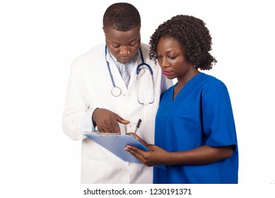 young trainee standing in uniform writing what the doctor tells him.