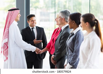 Young Translator Introducing Arabian Businessman To Business Partners