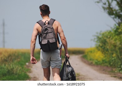 young traveler with a backpack on his shoulders on the road.Conceptual photo of traveler.
