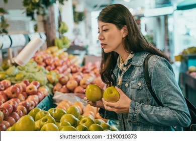 Young Traveler Buying Fruits In The Original Farmers Market, She Decided To Buy Those Green Apples And Still Picking The Others