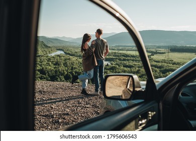 Young Traveler Couple on Road Trip, Man and Woman Enjoying Journey on Their Car Over Beautiful Landscape