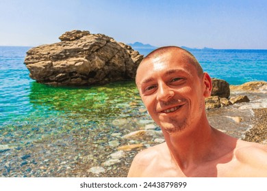 Young traveler hiker with natural coastal landscapes on Kos Island in Greece with mountains cliffs rocks turquoise blue beaches and waves. - Powered by Shutterstock