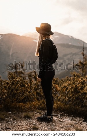Young traveler hiking girl with backpacks. Hiking in mountains. Tourist traveler. Hiking in Slovakia mountains landscape. Low Tatras national park, Slovakia.