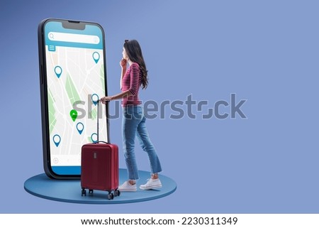 Young traveler searching for locations on a map, she is using a big smartphone, copy space