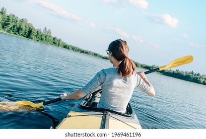 Young traveler woman is sailing on a boat to explore new places. Rear view of an explorer.