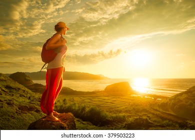 A young traveller looking at sunset on the island Lombok, Indonesia. Traveling along Asia, active lifestyle concept