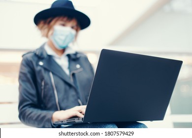 Young Trendy Woman In Mask Using Laptop Indoors, Depth Of Field