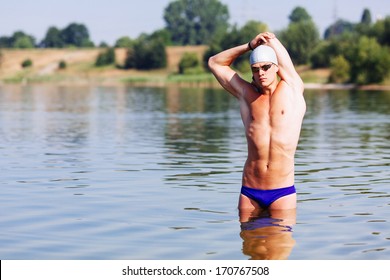 Young triathlonist stretching before the swim - Powered by Shutterstock