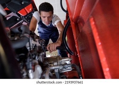 young truck mechanic at work - Shutterstock ID 2193937661