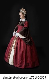 A Young Tudor Woman In A Red And Brown Dress And A French Hood