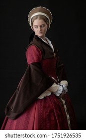 A Young Tudor Woman In A Red And Brown Dress And A French Hood