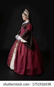 A Young Tudor Woman In A Red And Brown Dress And A French Hood