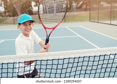 Young Tween Asian Boy Tennis Beginner Player On Outdoor Blue Court, Active Sport For Kid