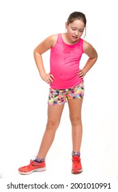 A young tween girl is sweaty and tired from exercise.