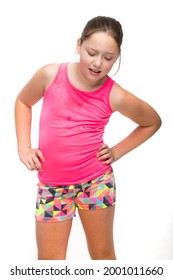 A young tween girl is sweaty and tired from exercise.