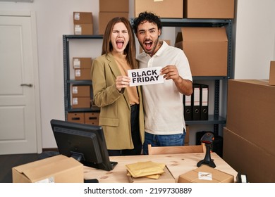 Young Two People Holding Black Friday Banner At Small Business Store Angry And Mad Screaming Frustrated And Furious, Shouting With Anger. Rage And Aggressive Concept. 