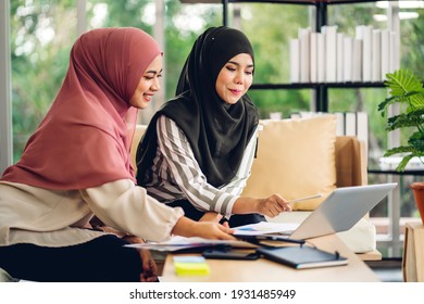 Young two smiling happy beautiful asian muslim woman relaxing using laptop computer and tablet working and video conference meeting at home.work from home concept