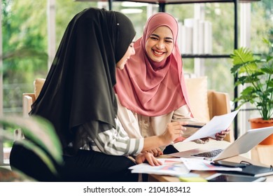 Young two smiling happy beautiful asian muslim woman relaxing using laptop computer working and meeting analyzing discussing strategy with startup project plan and brainstorm at home - Powered by Shutterstock