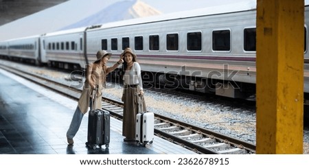 Young two woman with suitcase waiting for a train tourist adventure holiday traveling with mount fuji as the background concept transport lifestyle active journey and travel lifestyle